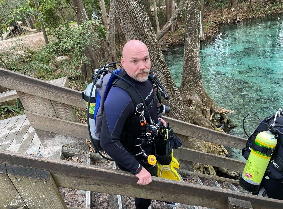 Weekly Diver Instructor getting into the water for another scuba lesson course