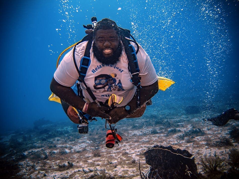 Weekly Diver Instructor showing his perfect bouyancy and smile underwater