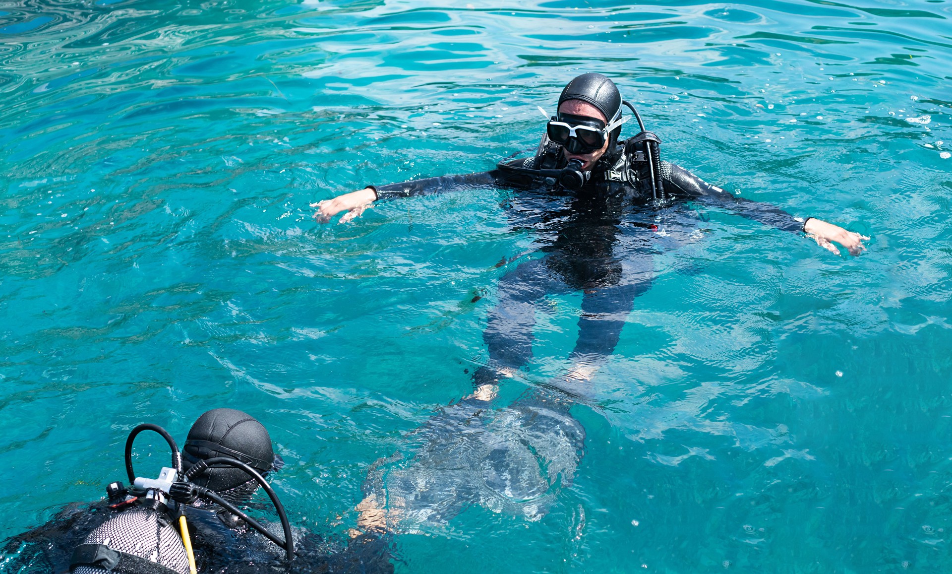 Diving lessons with an instructor. First time scuba dive. Selective focus.